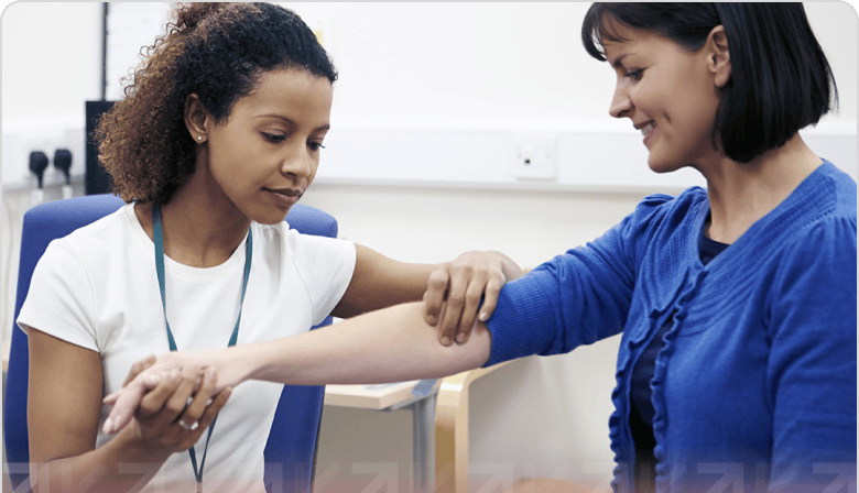 A health care professional touching  a patients arm