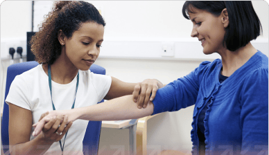 A health care professional touching a patients arm